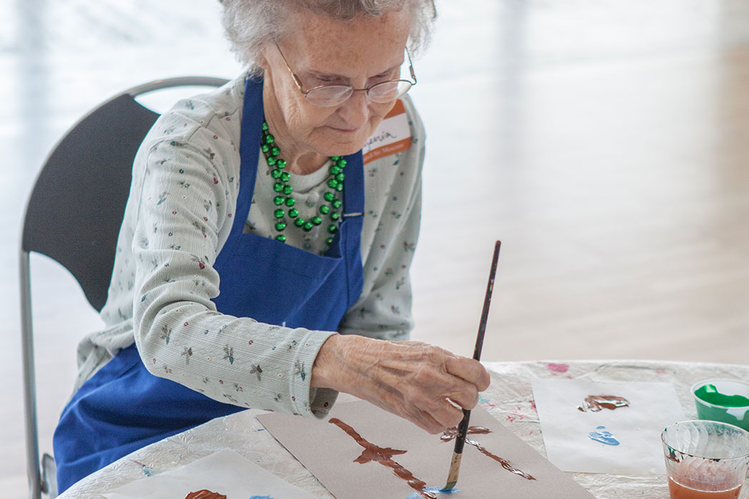an elderly woman painting