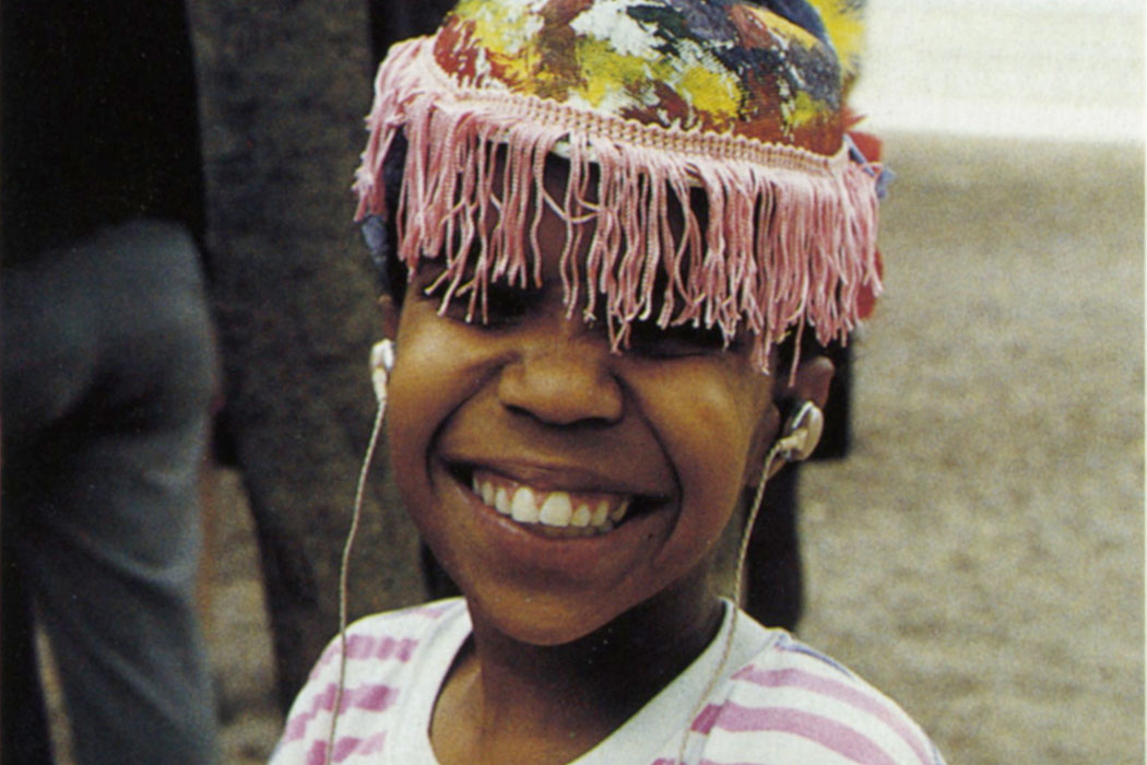 a child wearing a hat smiling