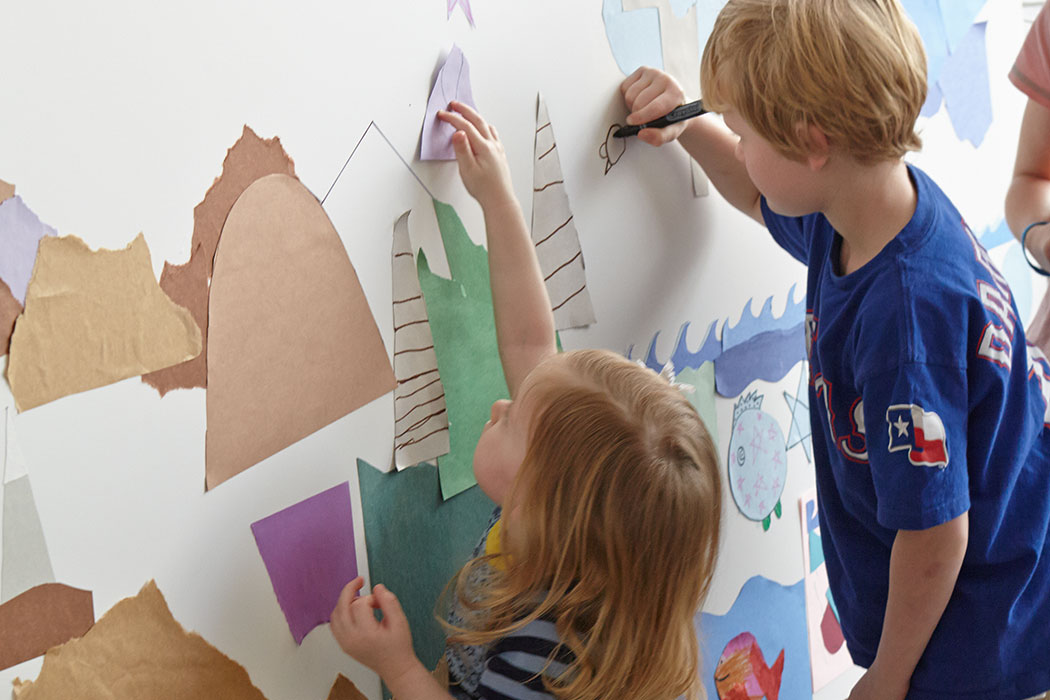 children drawing on an interactive wall display