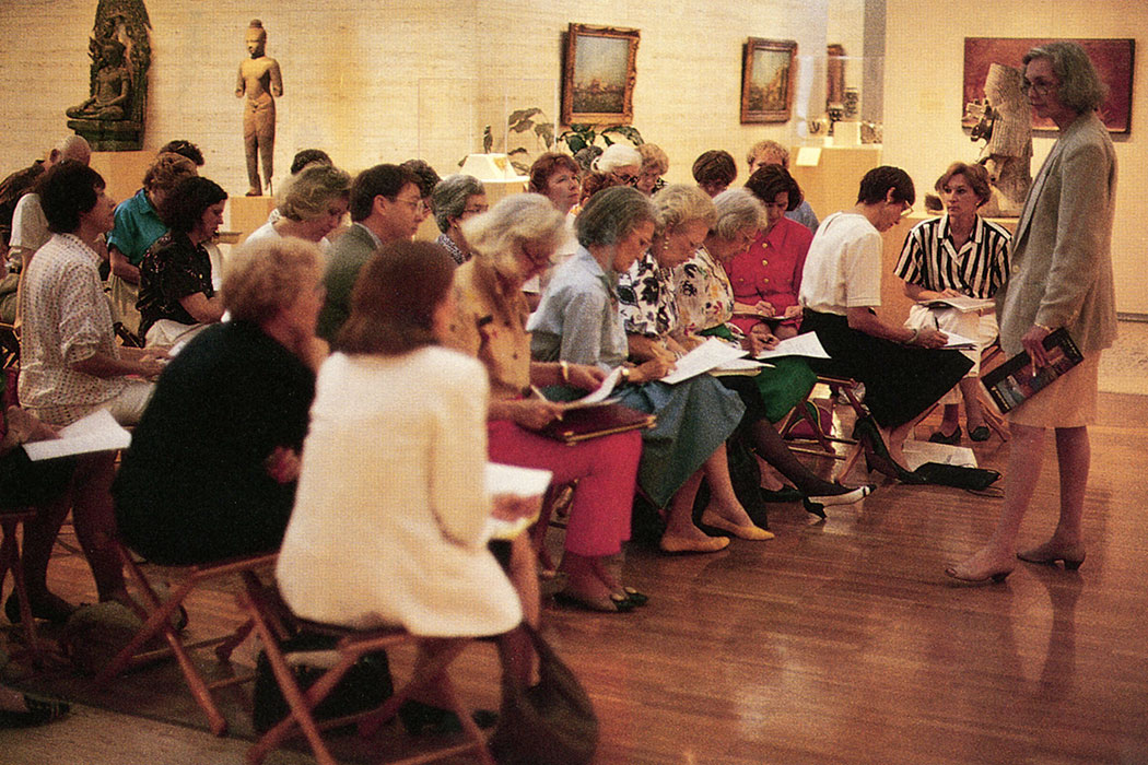 a group of visitors taking notes
