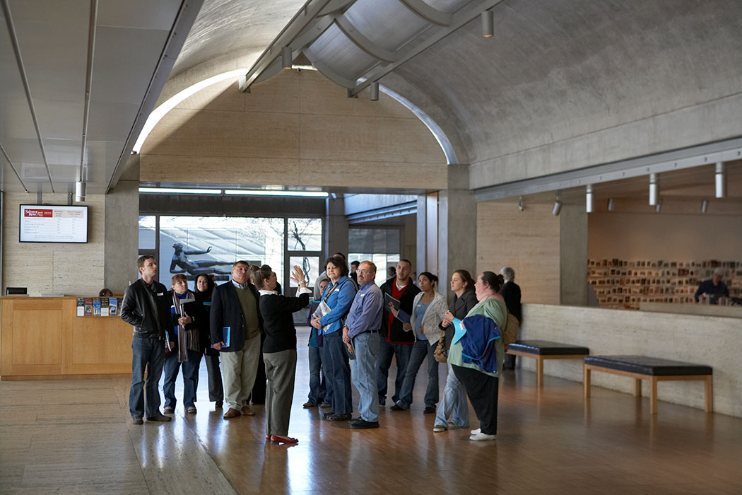 a Kimbell docent speaking to a group of visitors in an open room