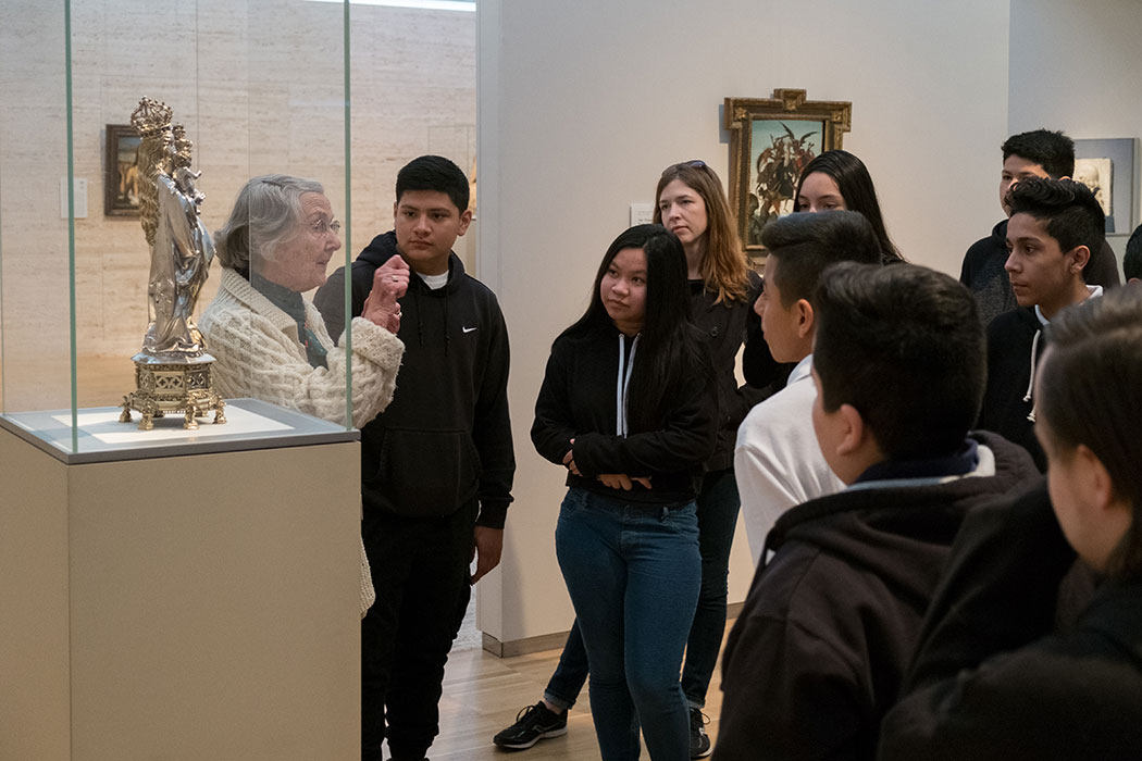a Kimbell docent speaking to a group of visitors near a sculpture