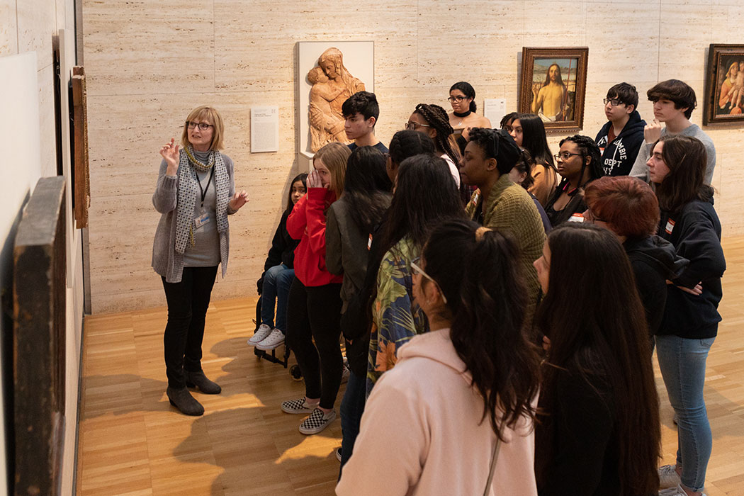 a Kimbell docent speaking to a group of visitors about a painting