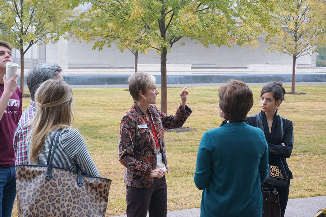 a Kimbell docent speaking to a group of visitors outside