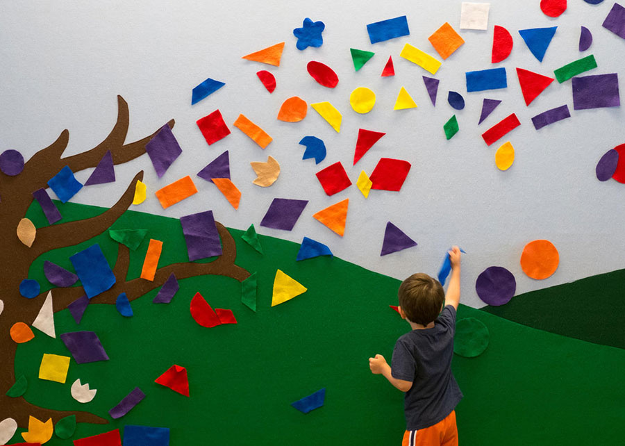 a child interacting with an interactive wall display