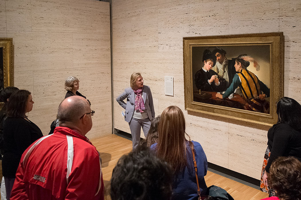a Kimbell docent with teachers admiring a Caravaggio painting