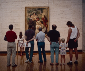 a group of people admiring a painting