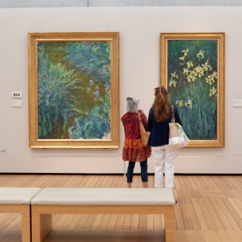 two visitors admiring a painting in the Monet: The Late Years exhibition
