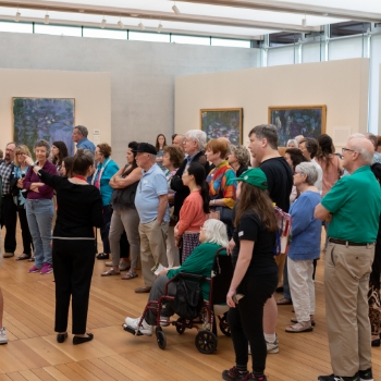 a Kimbell docent speaking to a group of visitors to the Monet: The Late Years exhibition